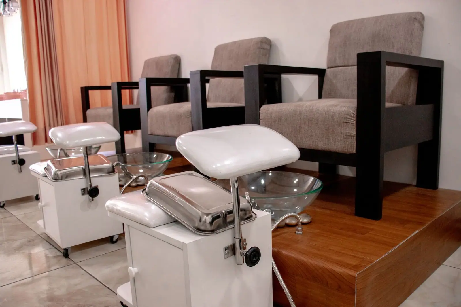 Stylish pedicure setup with comfortable armchairs and basins